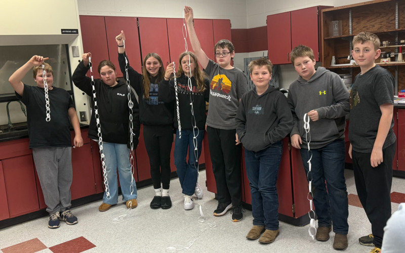 group of students holding a paper chain