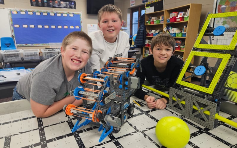 three boys with a robot